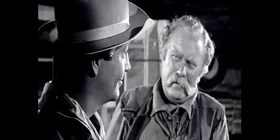Robert Taylor as Lance Poole, back from the war and getting reacquainted with old friend Zeke Carmody (Edgar Buchanan) in Devil's Doorway (1950)