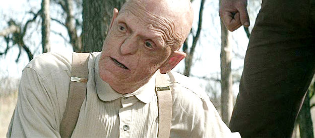 Michael Berryman as Dr. Pepperdine, the physician with a fondness for amputations in Kill or Be Killed (2015)
