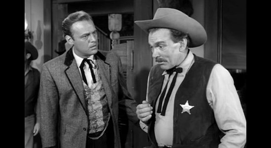 Charles Cooper as gambler Cole Fender, urging the sheriff (Walter Coy) into action because he smells a big reward in Gun Fight (1961)