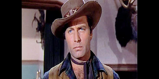 George Montgomery as Johnny Carver, a reformed outlaw who infiltrates Sam Bass's gang in Texas Rangers (1951)