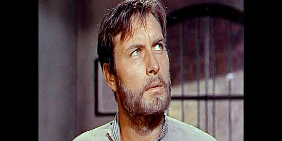 George Montgomery as Johnny Carver, contemplating the major's offer after time behind bars in Texas Rangers (1951)