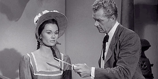 Gloria Talbott as Ruth Red Hawk being asked to identify a murder weapon by Temple Houston (Bill Williams) in Oklahoma Territory (1960)