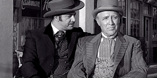 Grant Richards as Bigelow and Grandon Rhodes as George Blackwell, conspiring to make Temple governor in exchange for a few favors in Oklahoma Territory (1960)