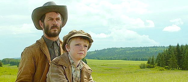 Greg Ellis as Tom Watson and Paul Sillito as Charley Watson, wondering what John Henry's reappearance will mean for the family in Forsaken (2015)