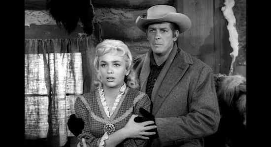 Joan Staley as Norah Blaine and James Brown as Wayne Santley, confronted by Brad's angry brother in Gun Fight (1961)