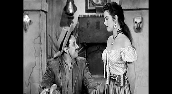 Jose Gonzalez-Gonzalez as El Raton, trying to gauge how much trouble he's in by questioning Polimita (Jeanne Carmen) in The Three Outlaws (1956)