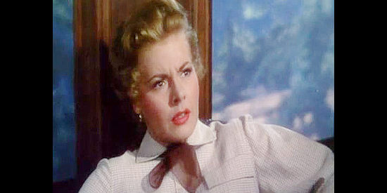 Kasey Rogers as Linda Prescott, realizing she recognizes one of the men involved in a train robbery in The Denver and Rio Grande (1952)