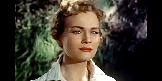Kristine Miller as Fay Warren, chasing Plummer off her family's property in Thunder Over Arizona (1956)