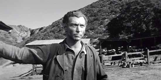 Lee Van Cleef as Ed McGaffey, wondering how to deal with a man who knows of his guilt as a killer in The Tin Star (1957)