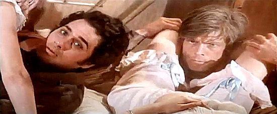 Manila finds Roy Colt (Brett Halsey) and Winchester Jack (Charles Southwood) in compromising positions in Roy Colt and Winchester Jack (1970)
