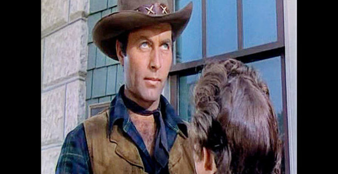 George Montgomery as Johnny Carver, spotting trouble beyond Helen Fenton in Texas Rangers (1951)