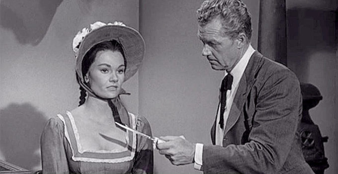 Gloria Talbott as Ruth Red Hawk being asked to identify a murder weapon by Temple Houston (Bill Williams) in Oklahoma Territory (1960)