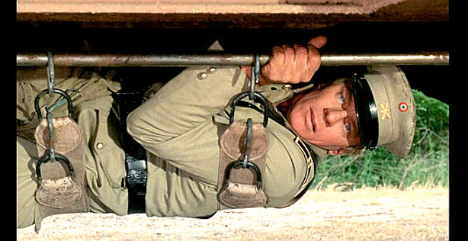 Peter Graves as The Dutchman, disguised in a Mexican army uniform for a train robbery in The Five Man Army (1969)
