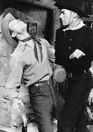 Randolph Scott as John Stewart slugs Skip Homeier as Adam Stewart in Ten Wanted Men (1955)
