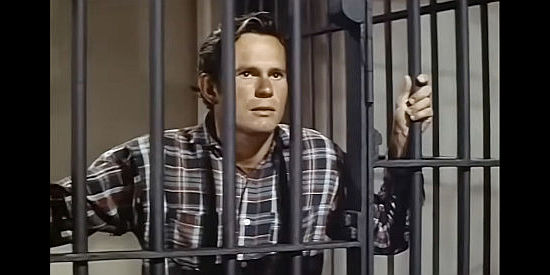 Robert Swan as Jud Warren, tossed in jail for killing a crooked sheriff in Thunder Over Arizona (1956)