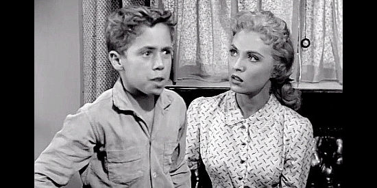 Scotty Morrow as Terry Sloane, recognizing the man who killed his mother as Della Cooper (Beverly Tyler) looks on in Toughest Gun in Tombstone (1958)