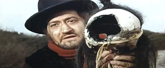Teodoro Corra as The Reverend finds the skull that's supposed to point the way toward the gold in Roy Colt and Winchester Jack (1970)