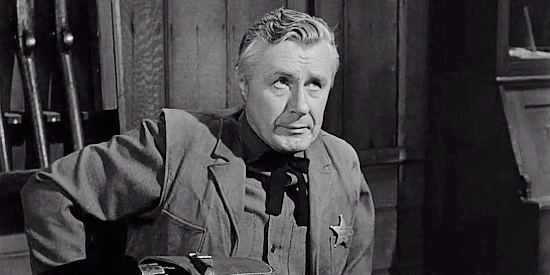 Tyler McVey as Sheriff Stoner, dodging questions about Sven Hansen's murder in Terror in a Texas Town (1958)