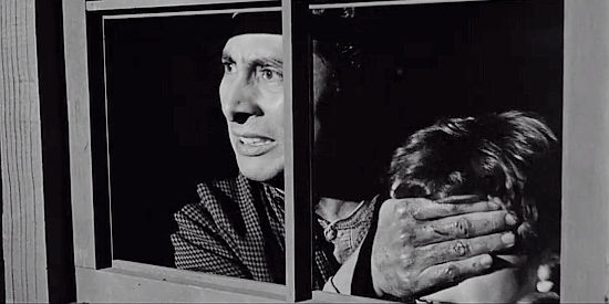 Victor Millan as Jose Miranda, shielding his son's eyes from a murder in Terror in a Texas Town (1958)