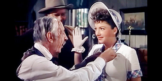 Anne Baxter as Kit Dodge, getting a badge from her lawman grandfather (Will Wright) in A Ticket to Tomahawk (1950)