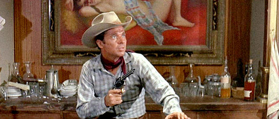 Audie Murphy as Jess Carlin, in a shoot-out in Luke Starr's saloon in The Texican (1966)