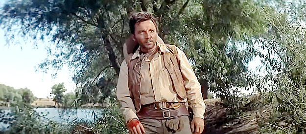 Cameron Mitchell as Clint Allison, his hand bloodied by an encounter with Nathan Stark in The Tall Men (1955)