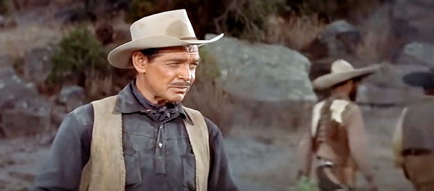 Clark Gable as Ben Allison, ordering his men to keep a close watch on Nella during an Indian scrape in The Tall Men (1955)