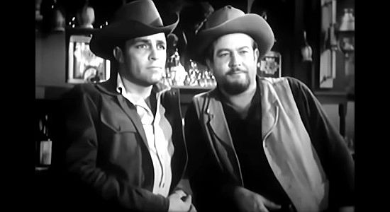 Dale Robertson as Caleb Whales and Charles Fredericks as Bear, watching outlaws run roughshod over the town they once protected in Hell Canyon Outlaws (1957)