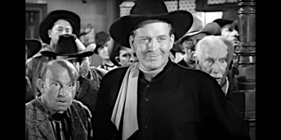 Dick Foran as Joel Benton, watching Ed Garry duke it out with a saloon patron suspect in Deputy Marshal (1949)