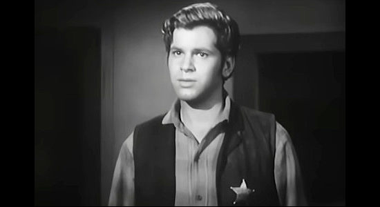 Dick Kallman as Smiley, the young man who thinks his fast gun means he's ready to stand up to the outlaw gang in Hell Canyon Outlaws (1957)