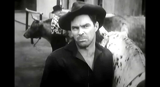 Don Megowan as Walt, a gang member throwing around his weight on the streets of Gold Ridge in Hell Canyon Outlaws (1957)