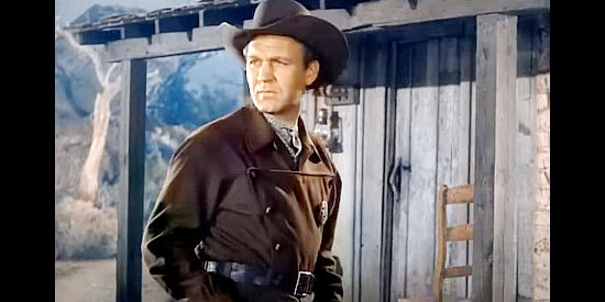 Forrest Tucker as Bucky, growing suspicious that old friend Zeb Smith is hiding something from him in Hellfire (1949)