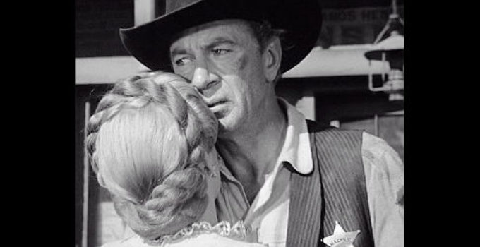 Gary Cooper as Marshal Will Kane embraces Grace Kelly as Amy in High Noon (1952)