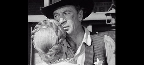 Gary Cooper as Marshal Will Kane embraces Grace Kelly as Amy in High Noon (1952)