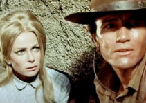 Giulia Rubini as Anna Sheridan and Anthony Steffen as Gary Hamilton, cornered by Acombar's men in A Stranger in Paso Bravo (1968)