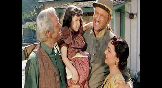 James Arness as Tiny McGilligan, back home from war and greeted by his family in Horizons West (1952)