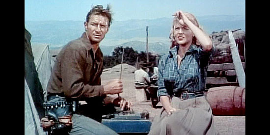 Jock Mahoney as Ross Granger and Peggie Castle as Ann Dennison, watching a rider approach in Overland Pacific (1954)