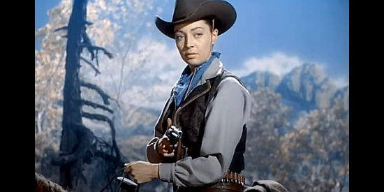 Marie Windsor as Doll Brown, an outlaw with a $5,000 price on her head and a wannabe preacher under her gun in Hellfire (1949)