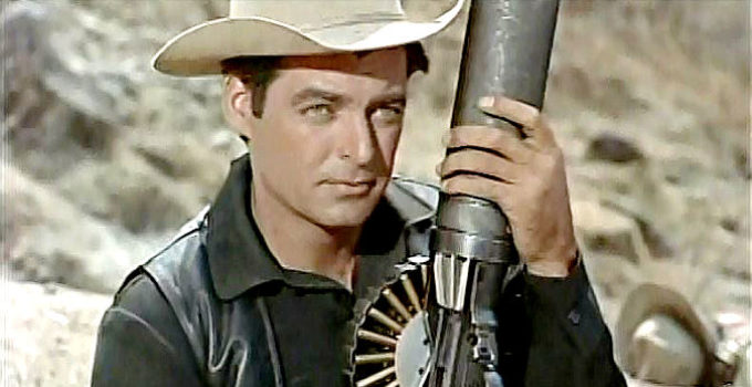 Rory Calhoun as Tom Bryan, a mercenary tooting the machine gun he calls La Cucaracha in The Treasure of Pancho Villa (1955)