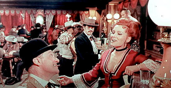 Piano player Curly (Alfredo Rizzo) and Joanne (Erika Blanc) treat saloon guests to a new song in Shotgun (1968)