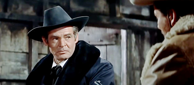 Robert Ryan as Nathan Stark, trying to convince the Allison brothers a cattle drive could be more profitable than a robbery in The Tall Men (1955)