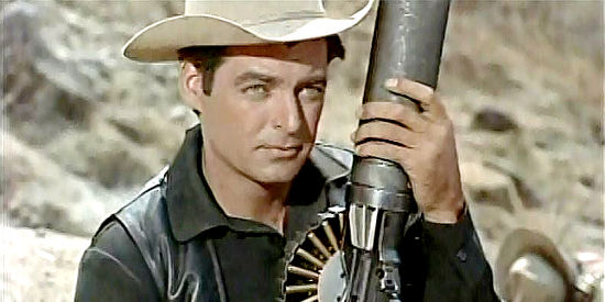 Rory Calhoun as Tom Bryan, a mercenary tooting the machine gun he calls La Cucaracha in The Treasure of Pancho Villa (1955)
