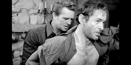 Sterling Hayden as Gil Hanley treating outlaw Vern Brechene (James Anderson) in Hellgate (1952)