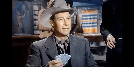 William Elliott as Zeb Smith, caught cheating at cards before he starts working on behalf of Father Joseph in Hellfire (1949)