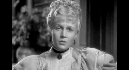 Ann Harding as Caroline Standish, de-escalating a tense situation involving her husband in The Conquerors (1932)