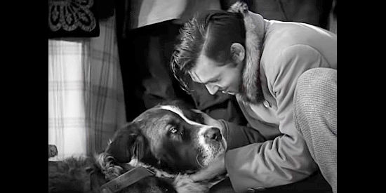 Clark Gable as Jack Thornton, thanking his dog Buck for helping him win a bet in Call of the Wild (1935)