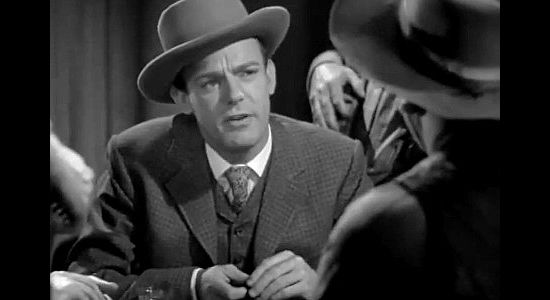 Dennis O'Keefe as Jeff Burton, aka The Kanarsy Kid, playing poker with Trigger Bill in The Bad Man of Brimstone (1937)