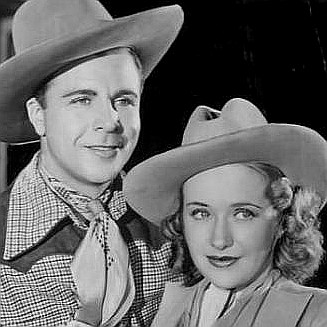 Dick Powell as Elly Jordan and Priscilla Lane as Jane Hardy in Cowboy from Brooklyn (1938)