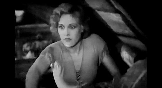 Esther Ralston as Ellen Colby, fearful someone will find the wounded man she's just hidden in her loft in To the Last Man (1933)