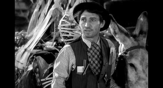George E. Stone as Sol Levy, selling wares on the streets of Osage and being harassed by Lon Yountis in Cimarron (1931)